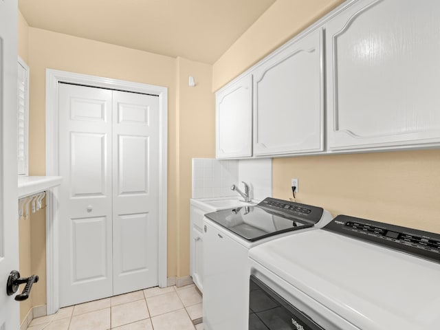 811 E Country View Cir, Fresno, CA 93730 - laundry area with light tile patterned flooring, washer and dryer, and cabinet space