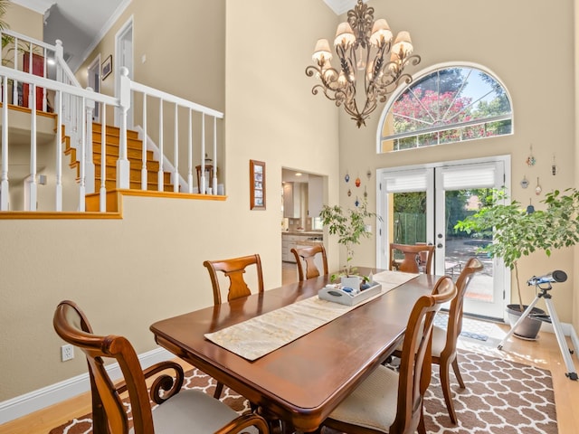 811 E Country View Cir, Fresno, CA 93730 - dining room with wood finished floors, a towering ceiling, stairs, french doors, and crown molding