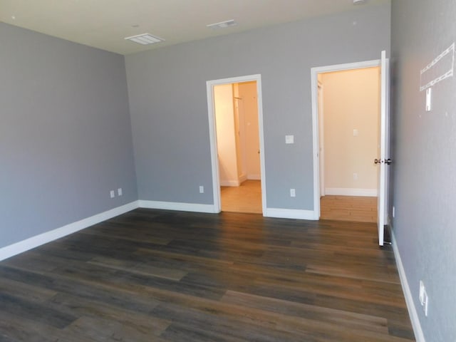 5875 E Pitt Ave, Fresno, CA 93727 - empty room with dark wood finished floors and baseboards
