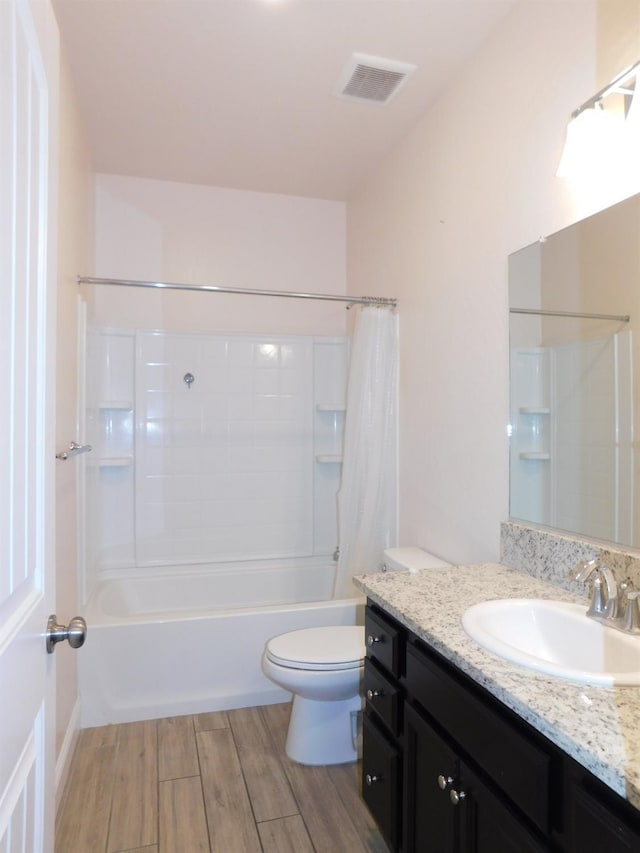 5875 E Pitt Ave, Fresno, CA 93727 - bathroom featuring vanity, toilet, shower / bathtub combination with curtain, and wood finished floors