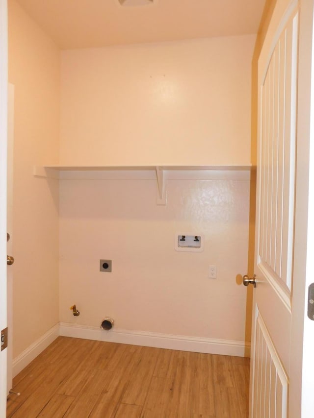 5875 E Pitt Ave, Fresno, CA 93727 - laundry area featuring light wood-type flooring, electric dryer hookup, gas dryer hookup, hookup for a washing machine, and baseboards