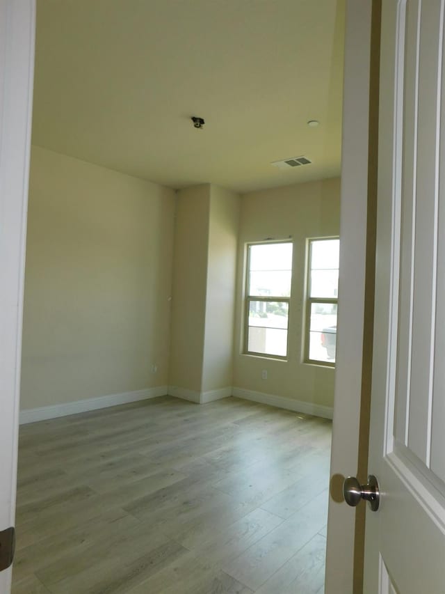 5875 E Pitt Ave, Fresno, CA 93727 - empty room featuring light wood-style flooring and baseboards