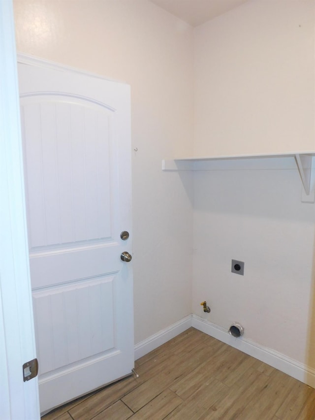 5875 E Pitt Ave, Fresno, CA 93727 - laundry area featuring light wood-style flooring, hookup for an electric dryer, and baseboards