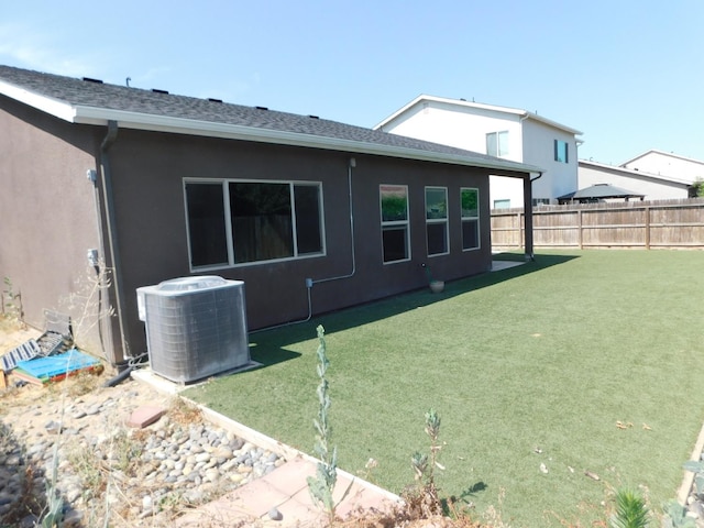 5875 E Pitt Ave, Fresno, CA 93727 - rear view of property featuring cooling unit and stucco siding