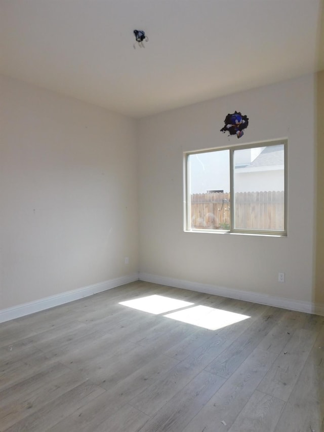 5875 E Pitt Ave, Fresno, CA 93727 - empty room featuring wood finished floors and baseboards