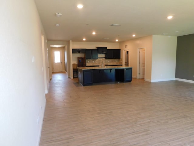 5875 E Pitt Ave, Fresno, CA 93727 - kitchen with open floor plan, tasteful backsplash, recessed lighting, light wood finished floors, and baseboards