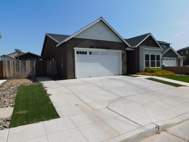 5875 E Pitt Ave, Fresno, CA 93727 - view of front facade featuring concrete driveway and an attached garage