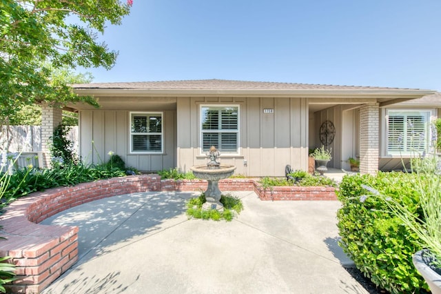 1758 Ash Ave, Clovis, CA 93611 - property entrance featuring a patio area, board and batten siding, and brick siding