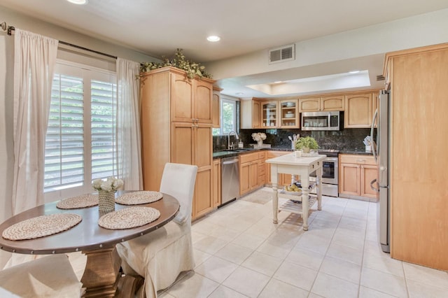 1758 Ash Ave, Clovis, CA 93611 - kitchen with stainless steel appliances, backsplash, dark countertops, glass insert cabinets, and recessed lighting