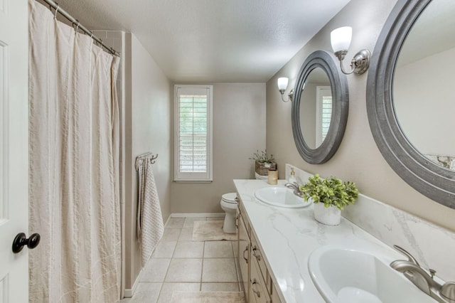 1758 Ash Ave, Clovis, CA 93611 - full bath featuring double vanity, toilet, tile patterned floors, baseboards, and a textured ceiling