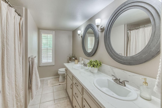 1758 Ash Ave, Clovis, CA 93611 - full bath featuring double vanity, toilet, baseboards, a textured ceiling, and tile patterned floors