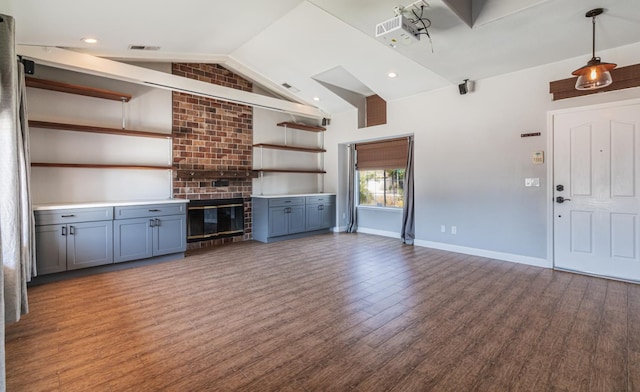 697 E Omaha Ave, Fresno, CA 93720 - unfurnished living room with wood finished floors, vaulted ceiling, baseboards, and recessed lighting