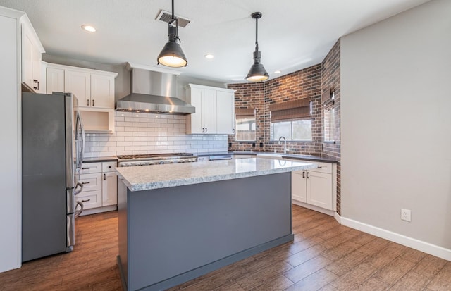 697 E Omaha Ave, Fresno, CA 93720 - kitchen featuring freestanding refrigerator, wall chimney range hood, recessed lighting, white cabinets, and dark wood-style floors