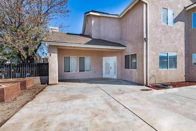 697 E Omaha Ave, Fresno, CA 93720 - rear view of house featuring french doors, stucco siding, a patio area, and a tiled roof