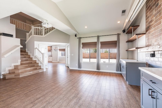697 E Omaha Ave, Fresno, CA 93720 - kitchen featuring open shelves, light countertops, plenty of natural light, wood finished floors, and high vaulted ceiling