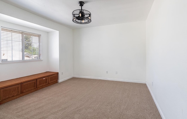 697 E Omaha Ave, Fresno, CA 93720 - spare room with light colored carpet, a chandelier, and baseboards