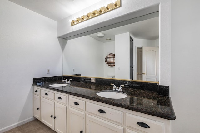 697 E Omaha Ave, Fresno, CA 93720 - bathroom with double vanity and baseboards
