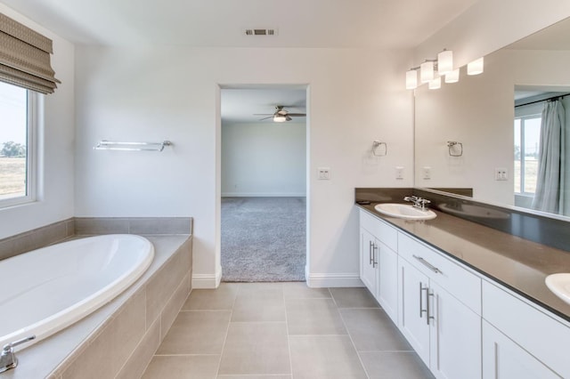3923 Morris Ave, Clovis, CA 93619 - bathroom featuring healthy amount of natural light, double vanity, a ceiling fan, and a bath