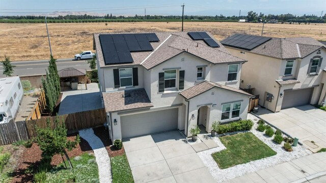 3923 Morris Ave, Clovis, CA 93619 - view of front of property featuring stucco siding, an attached garage, concrete driveway, and roof mounted solar panels