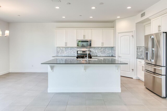 3923 Morris Ave, Clovis, CA 93619 - kitchen with stainless steel appliances, dark countertops, tasteful backsplash, a chandelier, and recessed lighting