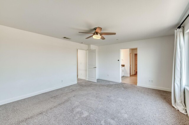 3923 Morris Ave, Clovis, CA 93619 - unfurnished bedroom featuring light carpet, baseboards, and ceiling fan