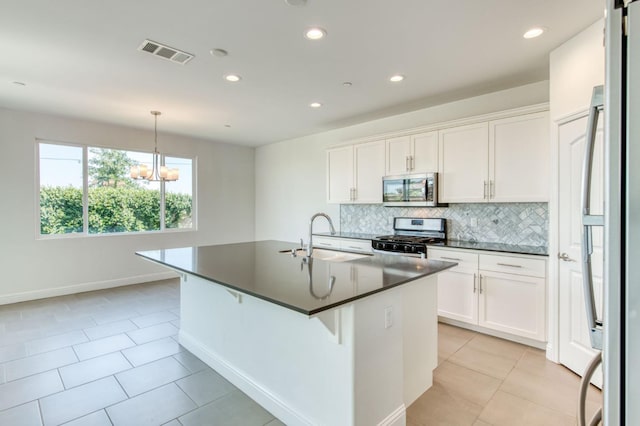 3923 Morris Ave, Clovis, CA 93619 - kitchen with appliances with stainless steel finishes, a sink, dark countertops, backsplash, and recessed lighting