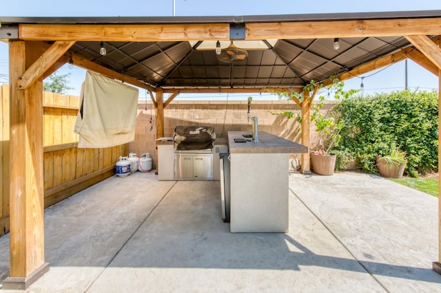 3923 Morris Ave, Clovis, CA 93619 - fenced backyard featuring a gazebo, exterior kitchen, a patio area, and a sink