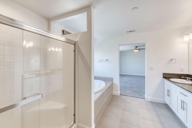 3923 Morris Ave, Clovis, CA 93619 - bathroom with vanity, ceiling fan, a stall shower, a garden tub, and tile patterned floors