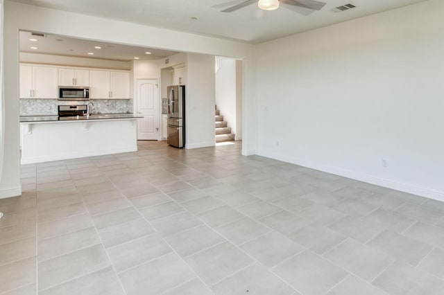 3923 Morris Ave, Clovis, CA 93619 - unfurnished living room with a ceiling fan, stairway, recessed lighting, and baseboards