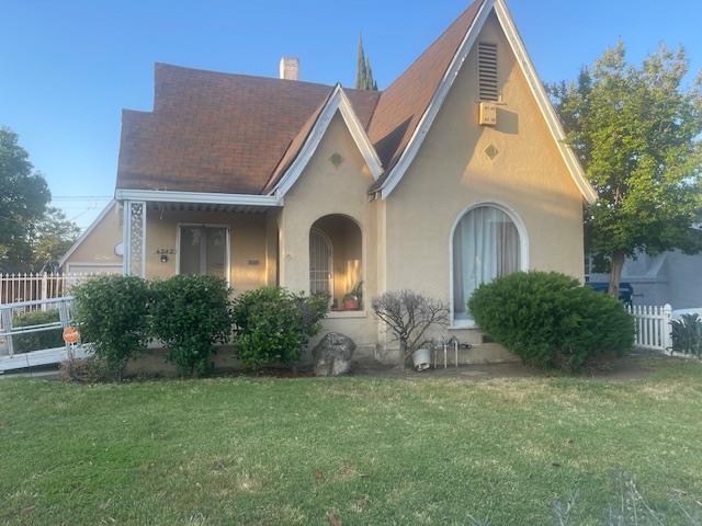 4242 E Illinois Ave E, Fresno, CA 93702 - tudor house featuring stucco siding and a chimney