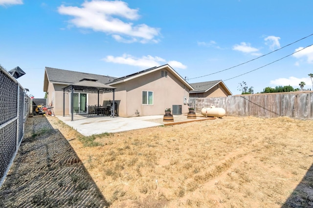 22375 Fairmead Cir, Chowchilla, CA 93610 - rear view of house with stucco siding, a gazebo, a fenced backyard, and a patio