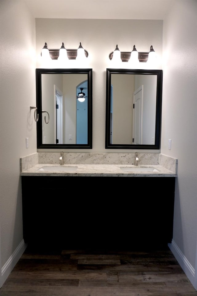 29030 Yosemite Springs Pkwy, Coarsegold, CA 93614 - bathroom featuring double vanity, wood finished floors, and baseboards