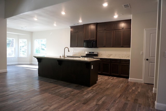 29030 Yosemite Springs Pkwy, Coarsegold, CA 93614 - kitchen featuring stainless steel range oven, black microwave, dark wood finished floors, dark brown cabinets, and an island with sink