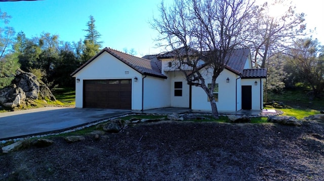 29030 Yosemite Springs Pkwy, Coarsegold, CA 93614 - view of front of property with an attached garage, driveway, a tiled roof, and stucco siding