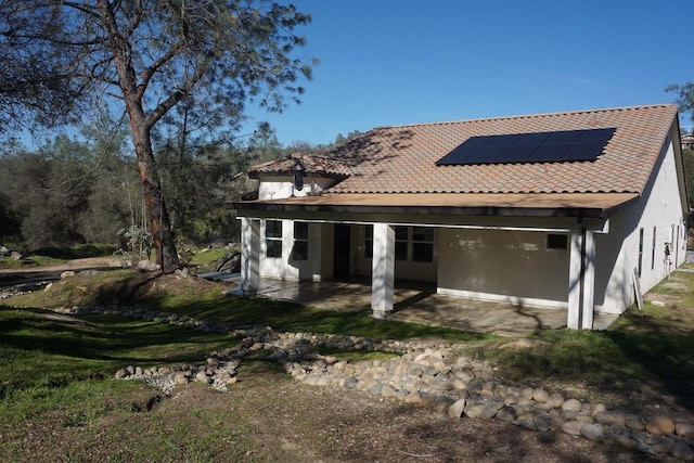 29030 Yosemite Springs Pkwy, Coarsegold, CA 93614 - back of property with a patio area, solar panels, and stucco siding