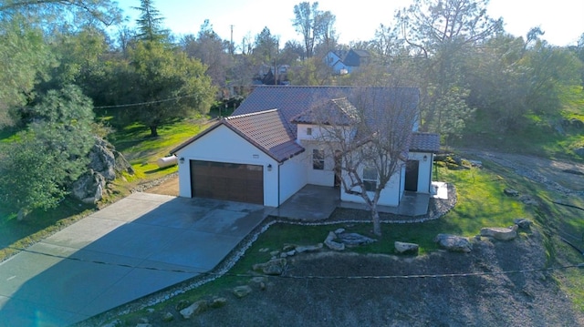 29030 Yosemite Springs Pkwy, Coarsegold, CA 93614 - view of front facade with a garage, driveway, stucco siding, and a front yard