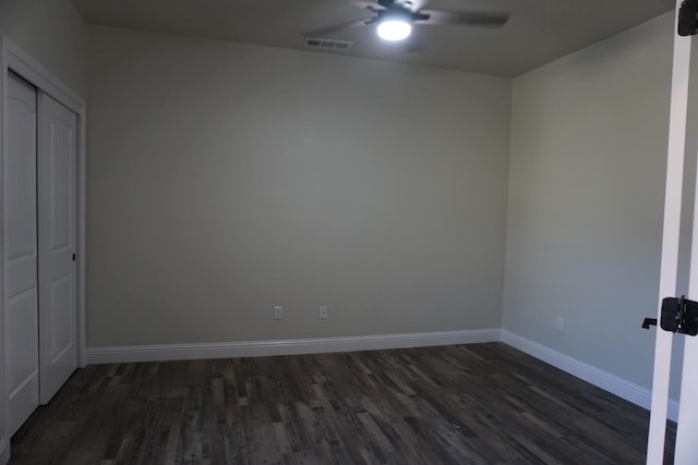 29030 Yosemite Springs Pkwy, Coarsegold, CA 93614 - unfurnished bedroom featuring dark wood-style floors, baseboards, a closet, and a ceiling fan
