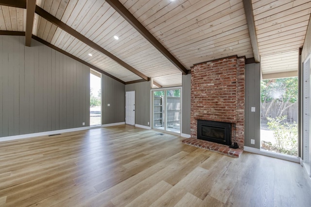 1904 S Fairway Ave, Fresno, CA 93727 - unfurnished living room featuring light wood finished floors, wood ceiling, a brick fireplace, and wooden walls