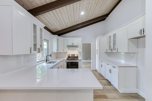 1904 S Fairway Ave, Fresno, CA 93727 - kitchen with stainless steel gas stove, a sink, wood ceiling, light wood-style floors, and glass insert cabinets