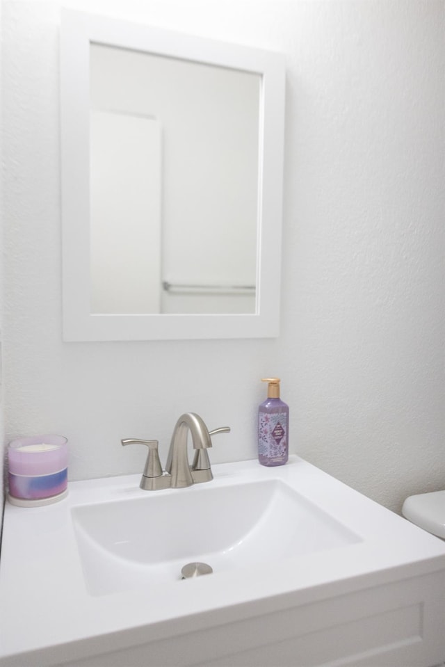 3870 N Fordham Ave, Fresno, CA 93727 - bathroom with vanity, toilet, and a textured wall