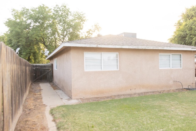 3870 N Fordham Ave, Fresno, CA 93727 - view of property exterior featuring stucco siding, a gate, and a shingled roof