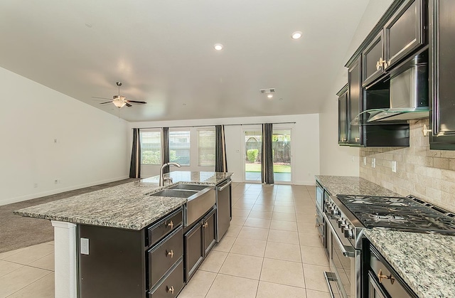 461 S Cascade Way, Madera, CA 93636 - kitchen with stainless steel appliances, open floor plan, light tile patterned floors, tasteful backsplash, and light stone countertops