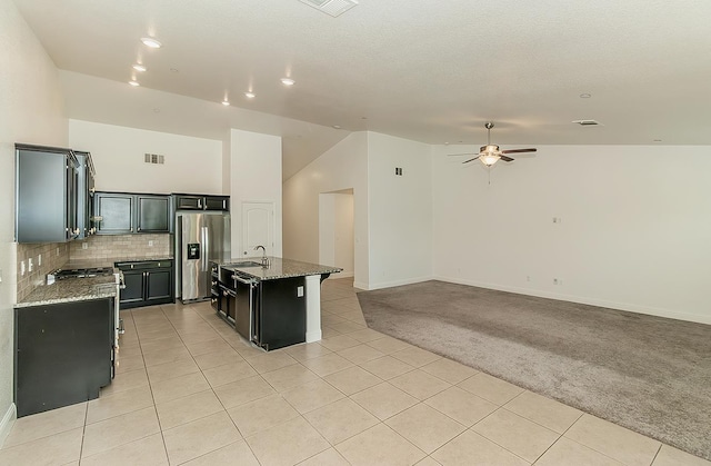 461 S Cascade Way, Madera, CA 93636 - kitchen with appliances with stainless steel finishes, light carpet, dark cabinets, a ceiling fan, and light tile patterned flooring