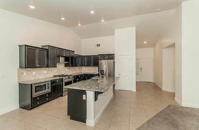461 S Cascade Way, Madera, CA 93636 - kitchen featuring stainless steel appliances, light tile patterned flooring, tasteful backsplash, light stone counters, and high vaulted ceiling