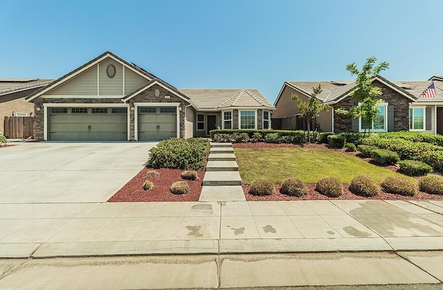461 S Cascade Way, Madera, CA 93636 - view of front of home with stone siding, a garage, and driveway