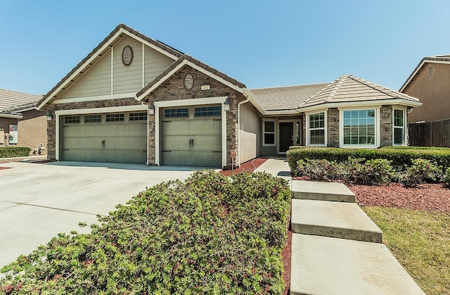 461 S Cascade Way, Madera, CA 93636 - ranch-style home with an attached garage, stone siding, driveway, and a tiled roof