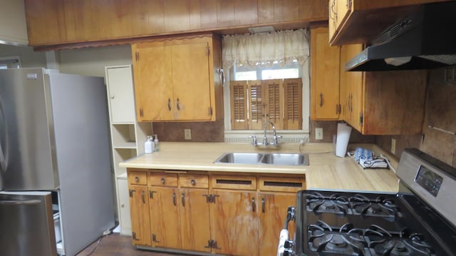 1625 N Woodson Ave, Fresno, CA 93705 - kitchen with appliances with stainless steel finishes, light countertops, under cabinet range hood, and brown cabinetry