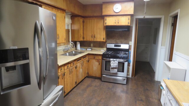 1625 N Woodson Ave, Fresno, CA 93705 - kitchen featuring stainless steel appliances, under cabinet range hood, dark wood-type flooring, and brown cabinets