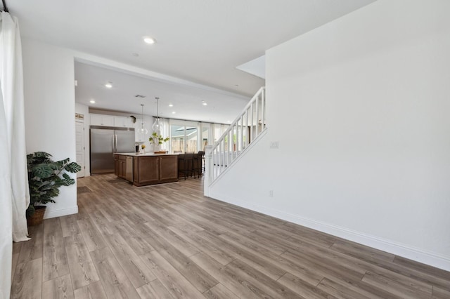 6406 E Giavanna Ave, Fresno, CA 93727 - living area with light wood-type flooring, stairs, and recessed lighting