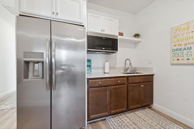 6406 E Giavanna Ave, Fresno, CA 93727 - kitchen featuring stainless steel appliances, light wood-style floors, light countertops, white cabinetry, and open shelves